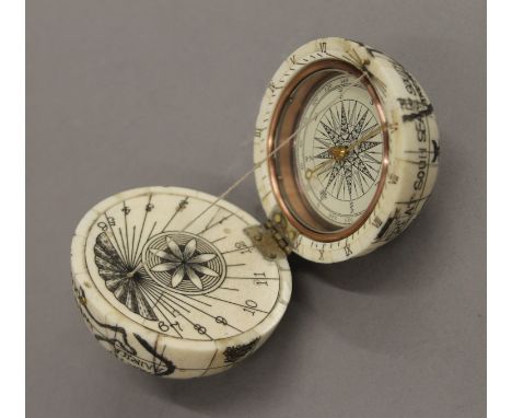 A bone globe compass. 7 cm high.