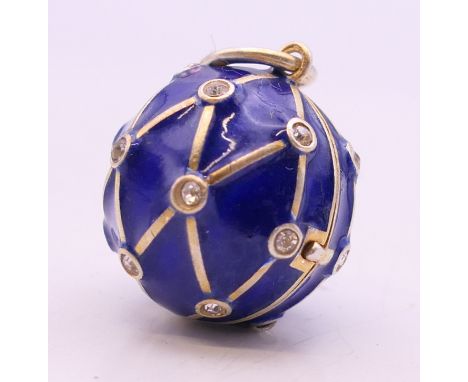 A silver blue enamel ball locket. 2 cm high.