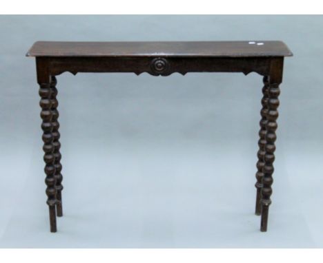 A Victorian oak bobbin twist hall table. 109 cm long.