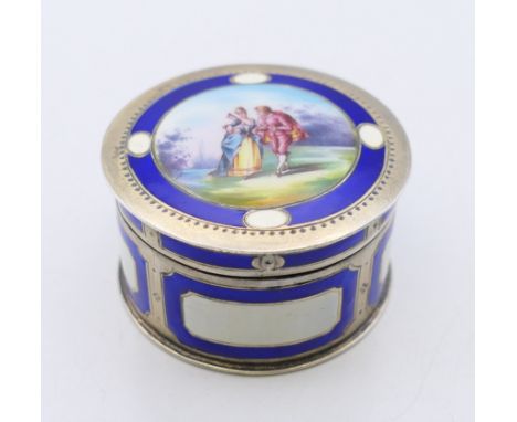 A Continental 800 silver and enamel pill box, the lid decorated with a courting couple.  4.5 cm diameter. 