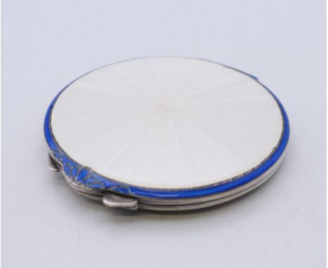 An enamel decorated silver compact, hallmarked for Birmingham 1949. 7.5 cm diameter.