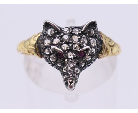 An unmarked gold diamond and ruby set fox mask ring. Ring size Q/R. 