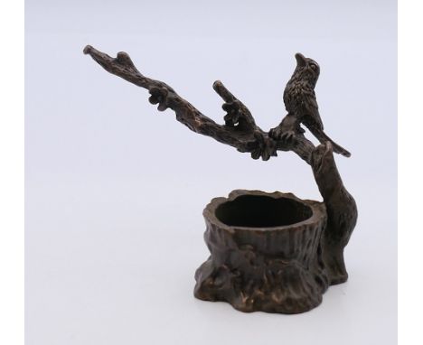 A bronze model of a bird in a tree. 6 cm high. 
