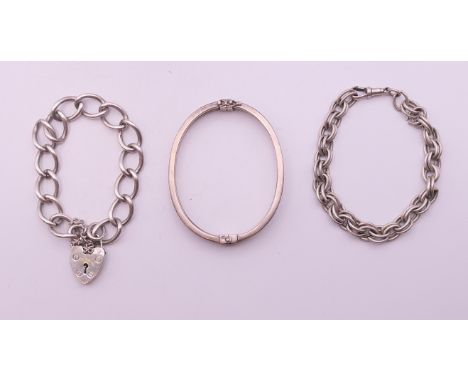 A silver bangle form bracelet and two other silver bracelets. The former 7 cm wide. 81.8 grammes. 