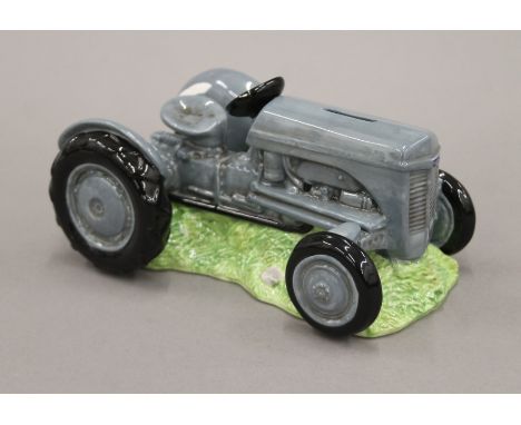 A Border Fine Arts porcelain tractor form money box. 22 cm long.