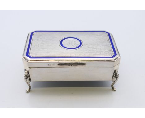 An enamel decorated silver trinket box, hallmarked for Birmingham 1913. 4 cm high, 8.5 cm wide, 5.5 cm deep.