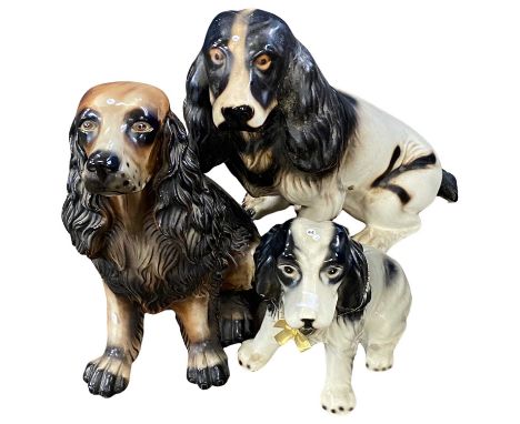 Three ceramic models of dogs, Spaniels and others, largest 43cm high