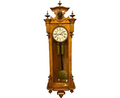 A 19th Century Vienna wall clock with brass twin weight movement and a white enamel dial (unsigned) set in a walnut veneered 
