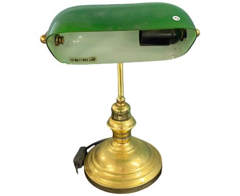 A brass based bankers lamp with green glass shade