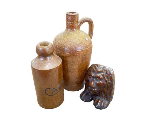 A ginger beer bottle Bourne Denby marked Caley together with a stoneware flask and a treacle glazed model of a lion