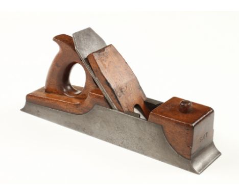 A Scottish style iron panel plane 13" x 2 1/2" with extended toe and heel, rosewood infill, closed handle and wedge held by l