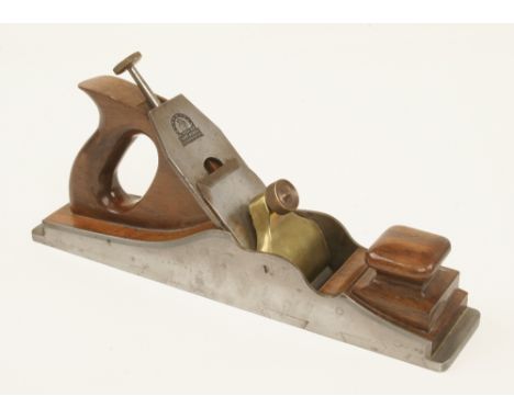 A fine quality 14 1/2" adjustable d/t steel panel plane with unusually deep dovetails and figured rosewood infill and handle 