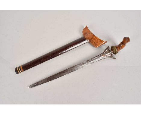 A Middle Eastern Kris knife, having carved wooden handle, with double edged 36cm long blade, complete with scabbard, no posta