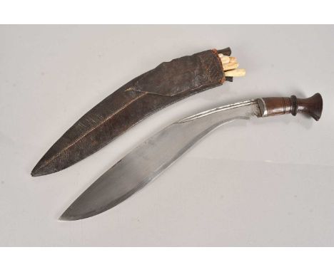 A Middle Eastern Kukri knife, having double fullered spine, 39cm long curved blade, with two skinning knives and six bone han