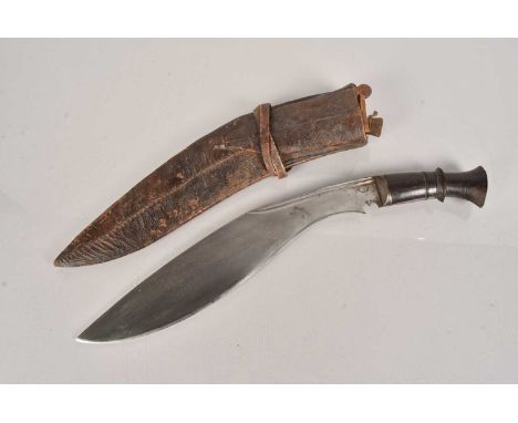 A Middle Eastern Kukri knife, having wooden handle, 34cm long curved blade, with double fullered spine, stamped symbol to the