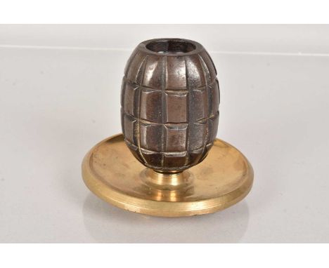 A WWI British Mills Grenade trench art, in the form of a candle stick, the top grenade on a brass dish base
