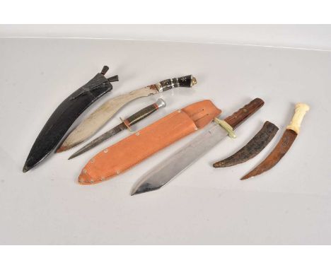 A group of four knives, to include a Kukri, a hunting knife with a Fairbairn Sykes style blade, a Middle Eastern example and 
