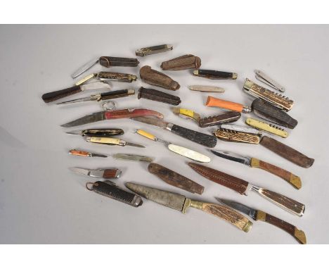 An assortment of various knives, to include Military Jack Knives, Hunting Knives, Pocket Knives and more, from various manufa