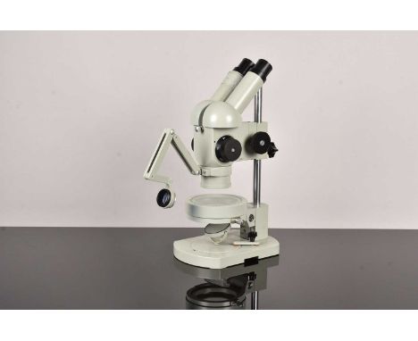 A Carl Zeiss Jena Binocular Microscope, possibly a SM-XX SMO Stereo Microscope, having grey painted metal body, no.555801, ha