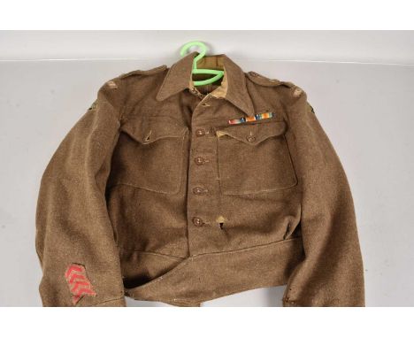 A 1940 Pattern Home Guard Battledress Blouse, dated 1943, size 7, complete with badges and medal ribbonsplease see additional