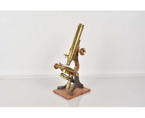 A vintage monocular microscope by Joseph Long of London, in original brass lacquer, adjustable fixed stage, with makers name 