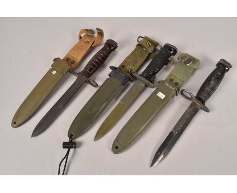 A US M5A1 Fighting Knife and scabbard, together with a US M7 by BOC with scabbard, together with another US Fighting knife (3