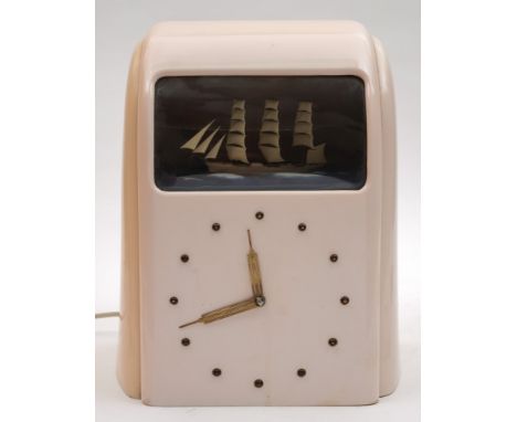 An Art Deco Vitascope pink Bakelite automaton ship clock:, the Odeon style case with enclosed model of a three masted clipper