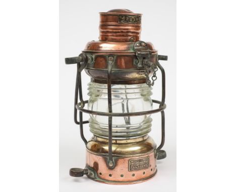 A copper and brass 'Anchor' lamp by Simpson Lawrence & Co Glasgow:, of cylindrical form with suspension loop and caged clear 