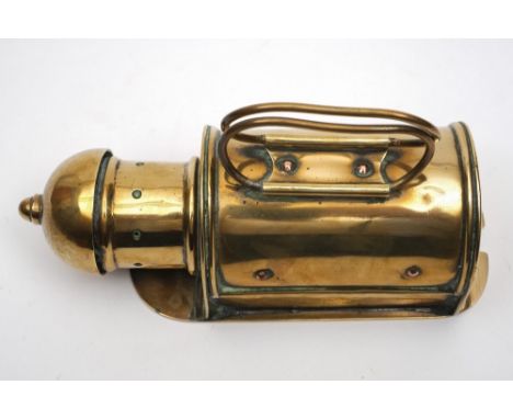 A  Victorian brass binnacle lantern:, the planished domed chimney over demi-lune body with folding handles and sliding plate 