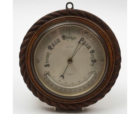 A circular oak cased  compensated aneroid barometer by Short & Mason Ltd, London:, the dial signed as per title  with thermom