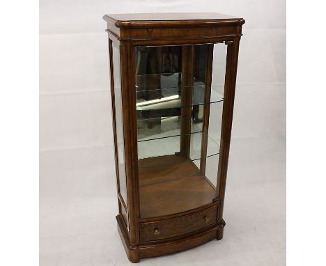 A modern glazed display cabinet, glass front and sides to two glass shelf interior supported in walnut veneer, 62 cm wide x 1