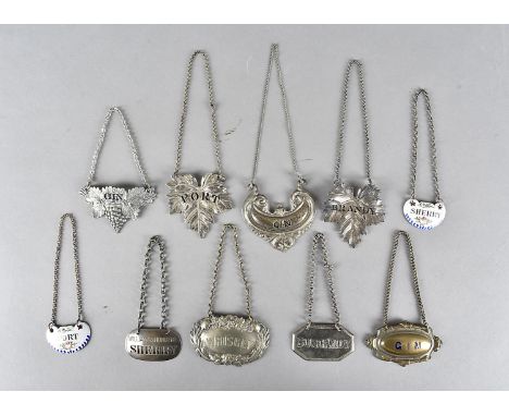 A collection of decanter labels, including silver plate, white metal and ceramic, comprising Gin, Port, Sherry and Whiskey (p