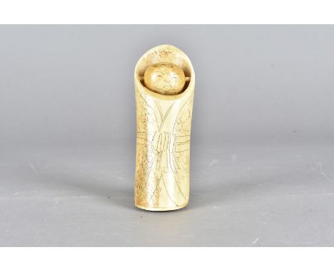 A vintage Japanese bone toy/novelty item, the bone body having engraved kimono decoration, with bone spinning head to the top