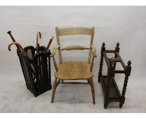 Two 20th Century oak stick stands, and an elm kitchen armchair together with various sticks (parcel)