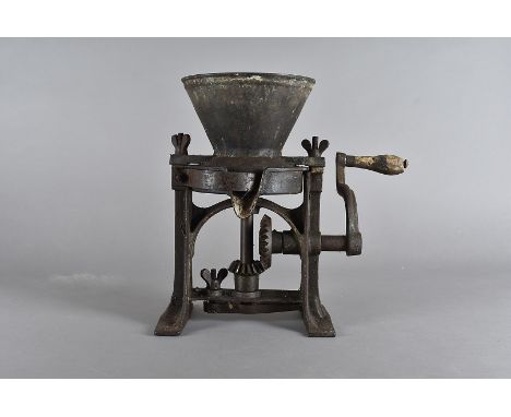 A cast iron Victorian paint grinder, with ratchet and pin mechanism, soft wood handle, 31 cm high