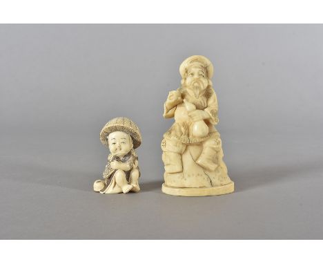 A 19th Century Japanese Okimono, the ivory carved figure modelled seated as a drunken man with a flagon of wine and cup in ot