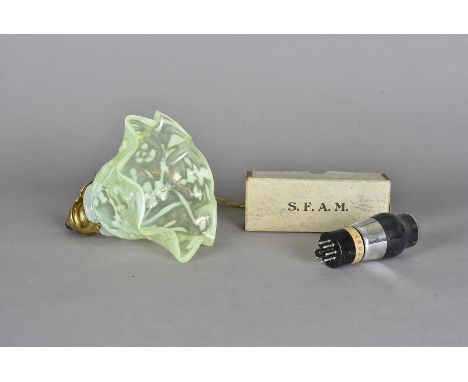 An art nouveau vaseline glass shade, with lacquered gilt brass fittings and ceramic wall mount with floral design, the crimpe