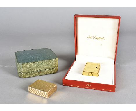 A yellow metal Dupont lighter, in fitted case, having cardboard sleeve, together with another yellow metal Dupont lighter and