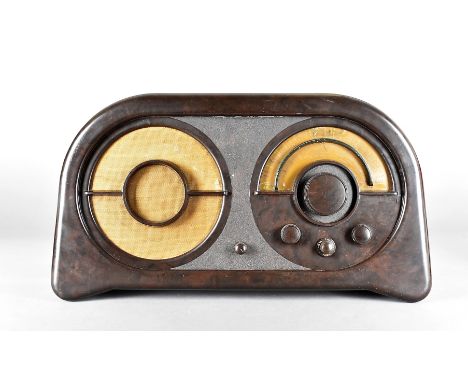 An Ekco, RG86 Bakelite radio, of semi circular shape, with replacement dials, knobs and manual copies, 56 cm x 30.5 cm high x