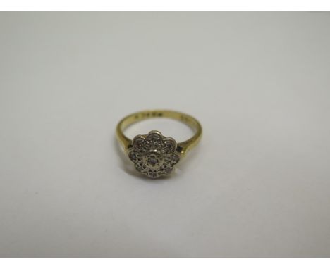 A hallmarked 18ct yellow gold diamond daisy ring size K with deceptive setting - approx weight 2.5 grams 