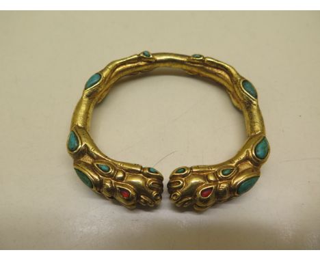 A gilt metal dragon bangle - 8cm x 7cm 