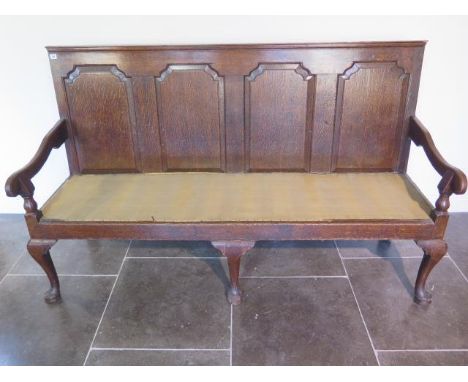 A Georgian oak hall settee bench with panelled back and scroll arms on cabriole shaped front legs - Height 110cm x 184cm x 68