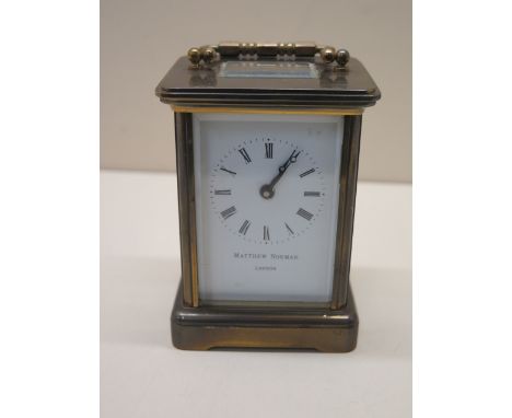 An 8 day brass carriage clock by Matthew Norman of London - working order - generally good - Height 12cm 