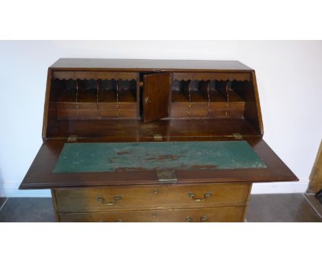 A Georgian mahogany five drawer bureau on ogee bracket feet, 110cm tall x 116cm x 55cm, with a fitted interior 