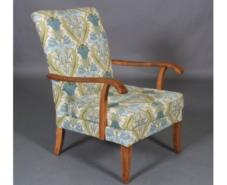 A Parker Knoll model 717 open armchair, upholstered in ivory, blue and green fabric, on short legs