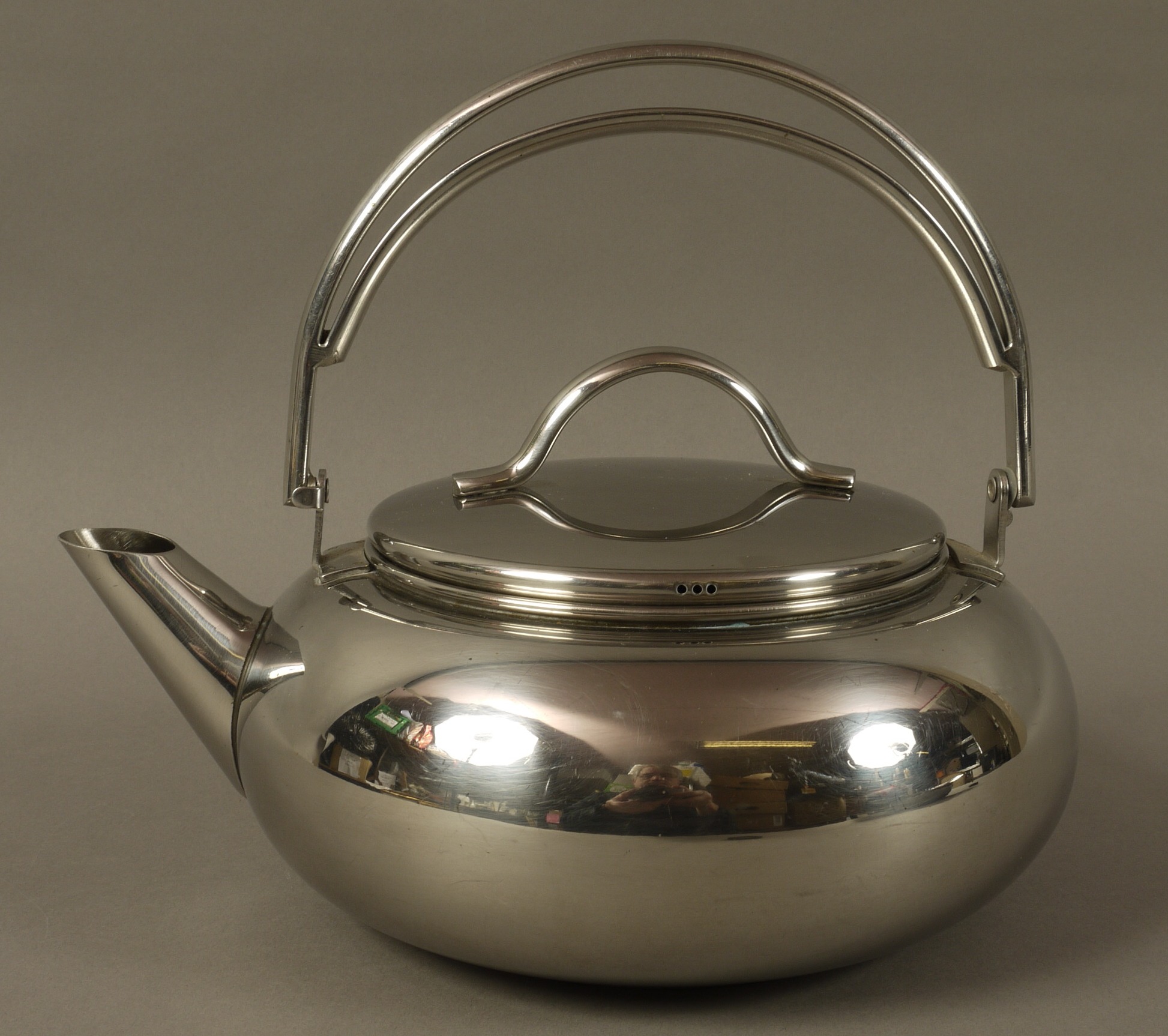 A stainless steel AGA kettle of compressed cauldron shape, slightly