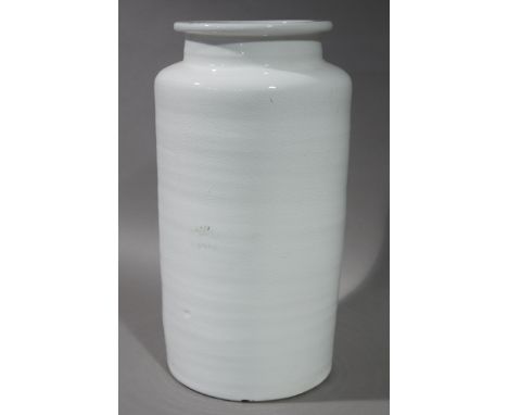 A large white ceramic vase of cylindrical form 