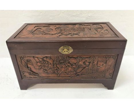 CHINESE CAMPHOR WOOD CHESTwith profuse all over carving, standing on bracket feet, 105cm wide 