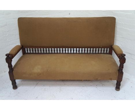 IN THE MANNER OF LIBERTY'S OF LONDONan Aesthetic movement mahogany framed sofa with a padded back, seat and arms, the back ra