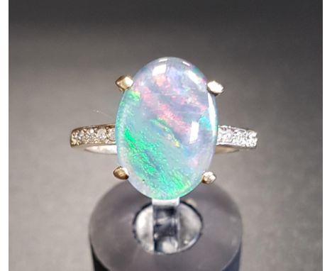 OPAL TRIPLET AND DIAMOND RINGthe central oval opal triplet flanked by diamond set shoulders, on nine carat gold shank, ring s